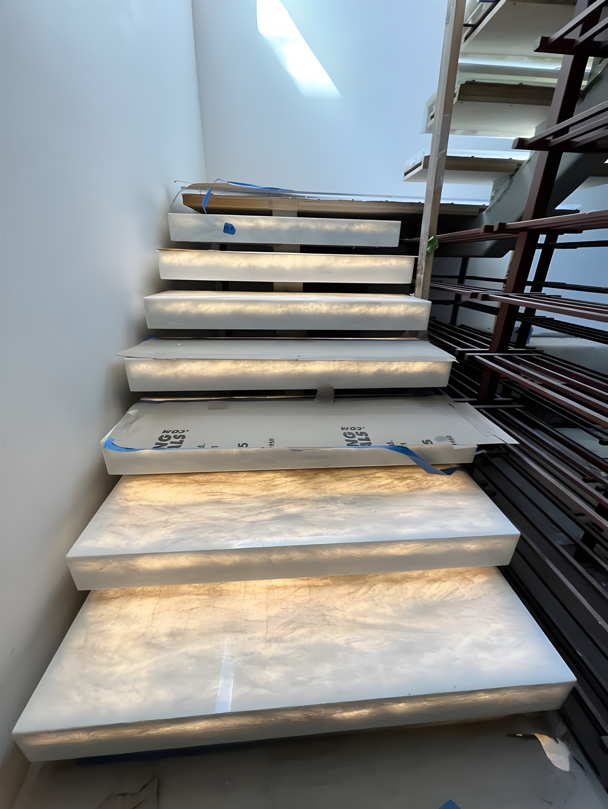 Backlit onyx stair treads pre-fabricated and burned-in at the LIT Group shop in Van Nuys before delivery to the job site.