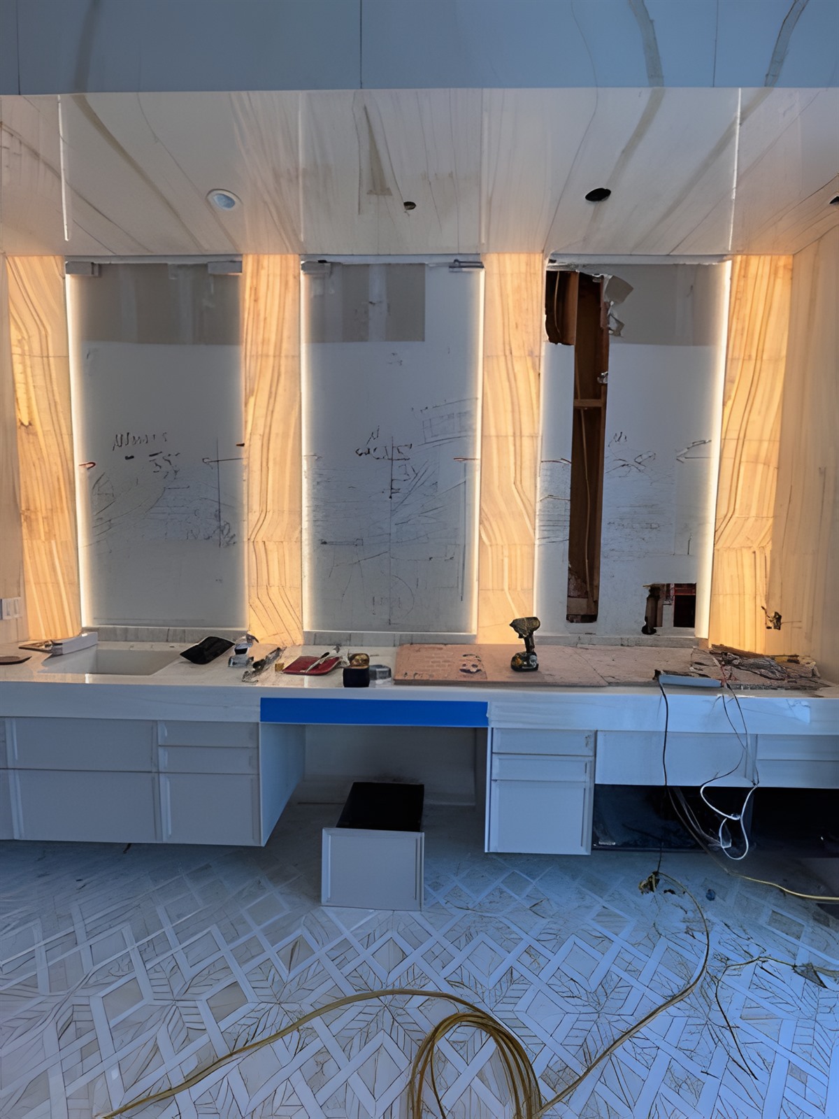 Backlit translucent stone panels mid-install on a luxury residential job site &mdash; specialty LED scope coordinated with the GC by LIT Group.