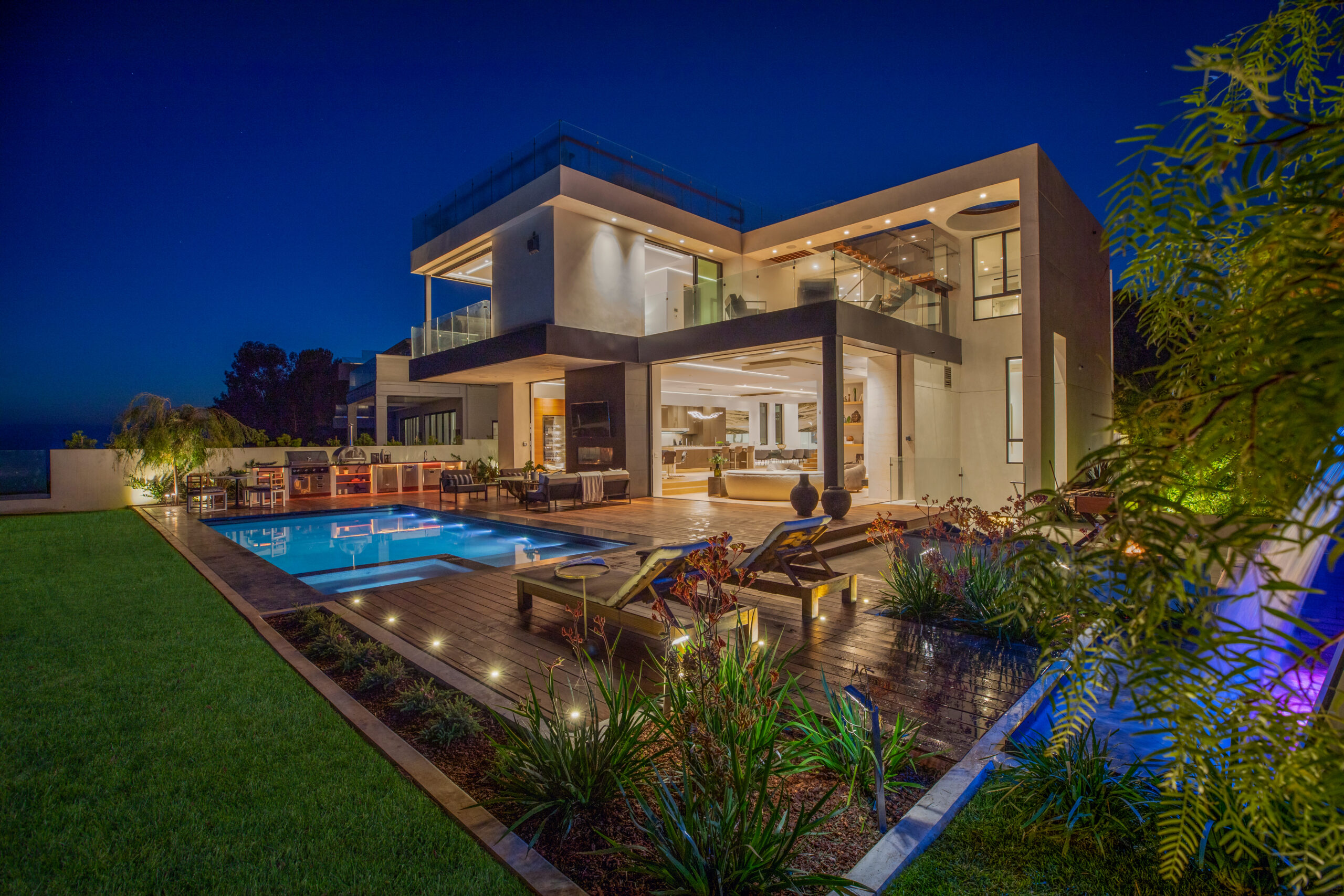 LIT Group architectural LED lighting at the DePauw residence, Pacific Palisades - exterior evening view with continuous linear cove lighting integrated into the home.