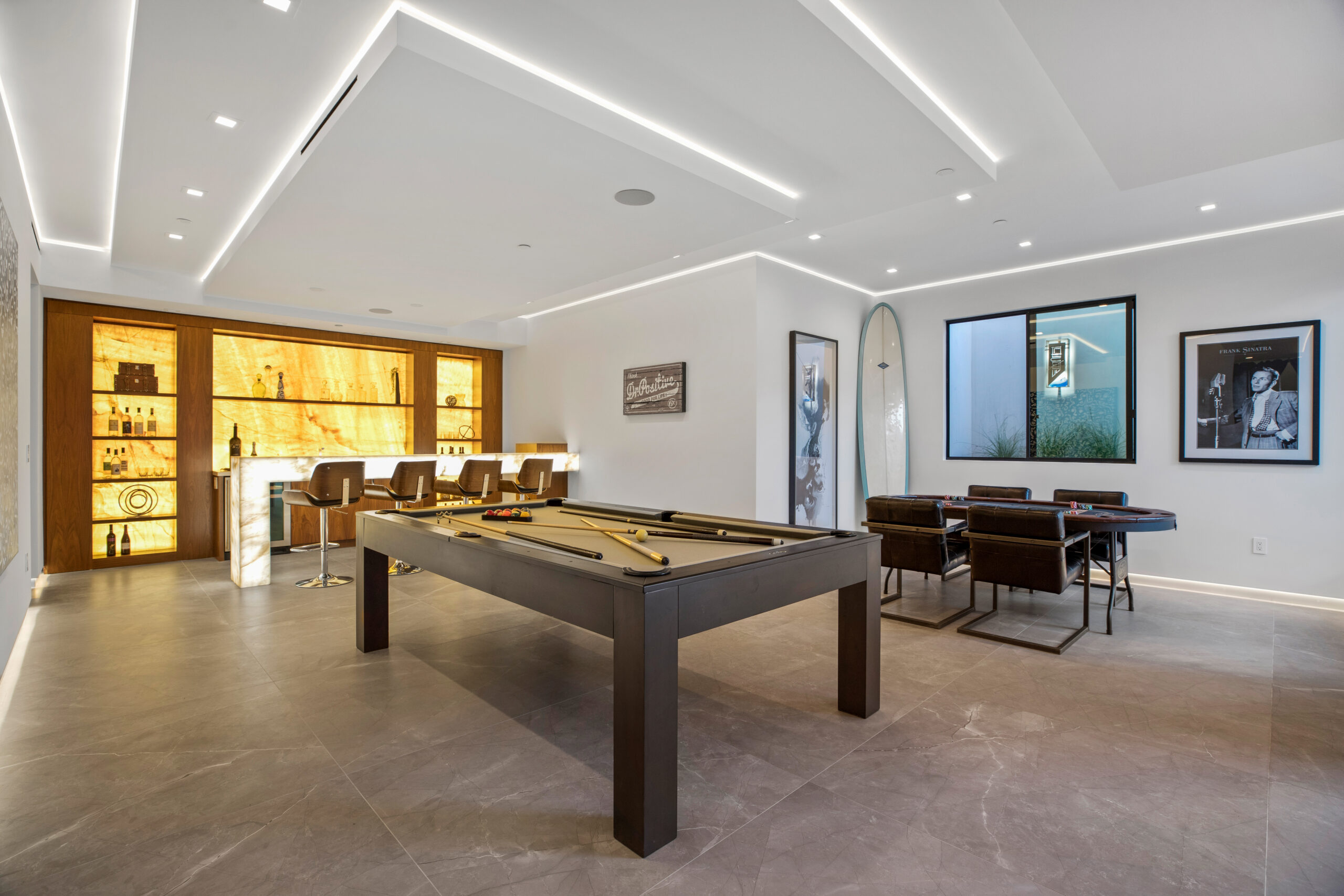 Continuous reveal lighting along an architectural wall plane - Pacific Palisades residence by LIT Group.